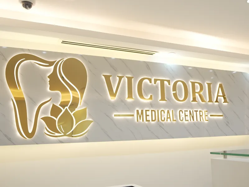 Illuminated Victoria logo wall at reception